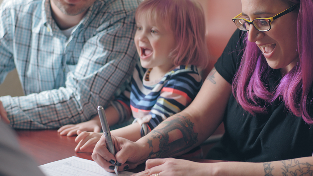 Mom and Daughter Smiling at Desk