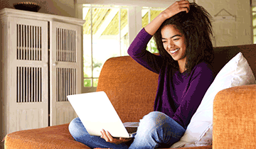 woman on couch with laptop