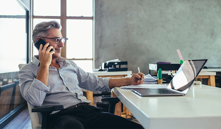 Caucasian Male Business Owner Sitting At Desk