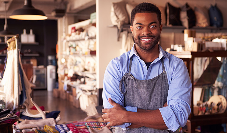 African American Male Standing In Shop