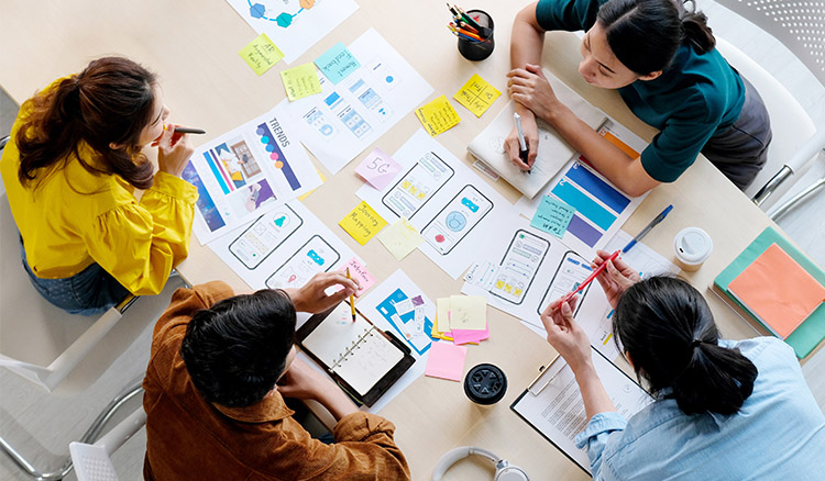 Four Coworkers Collaborating At Table